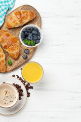 Coffee, juice and croissants breakfast