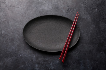 Empty plate and chopsticks