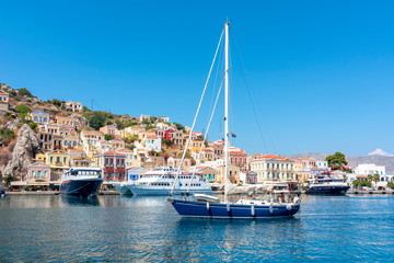 Fototapeta na wymiar Boats and yachts in Symi port, Dodecanese islands, Greece