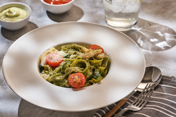 Homemade Tagliatelle pasta with zucchini, tomatoes and cod