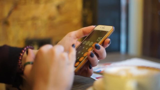woman using calculator application on smartphone