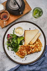 Omelet with herbs, bread and butter. Healthy breakfast