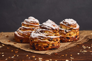 Tasty sweet buns with raisins and icing sugar. Homemade baking concept