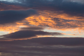 Dramatic evening sky backgound. Golden sunset heaven. Scenic sky with clouds in dust. Twilight concept. Colorful cloudscape. Beautiful dawn background. Space and peace concept.