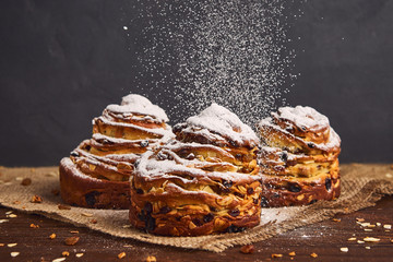 Tasty sweet buns with raisins and icing sugar. Homemade baking concept