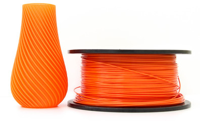 Orange vase and filament for 3d printing, isolated on white background, produced from pla, horizontal view, macro - obrazy, fototapety, plakaty