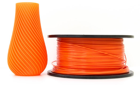 Orange vase and filament for 3d printing, isolated on white background, produced from pla, horizontal view, macro