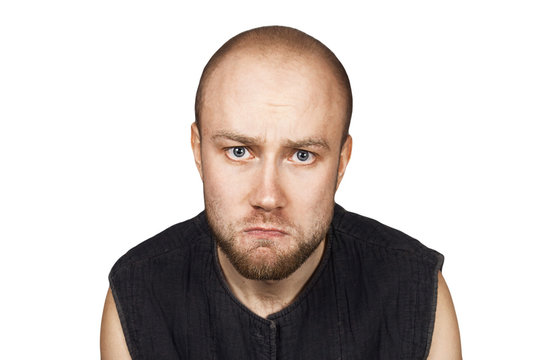 portrait of a bald upset offended man experiencing stress due to problems on an isolated white background