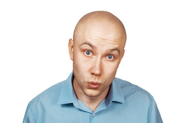 Portrait bald unsure man doesn't understand anything . guy in a blue shirt on white isolated background in perplexity