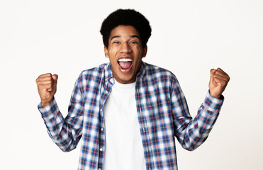 Fototapeta premium Yes, I did it! Guy celebrating victory over white background