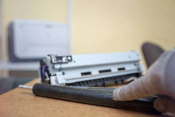 Specialist repairs laser printer. Worn and torn thermal film. Faulty thermal node