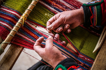 Weaving woman, hand-made colorful materials.