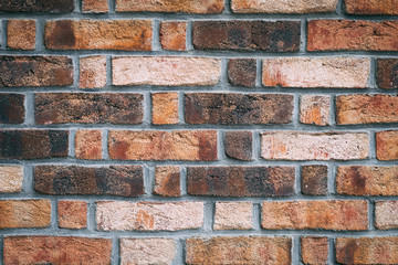 texture. The wall on it is brick. red, gray, black. neatly arranged in a row.