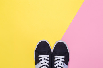 Sneakers on pink and yellow background. Fashion blog or magazine concept.