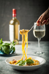 Young woman eating tasty pasta