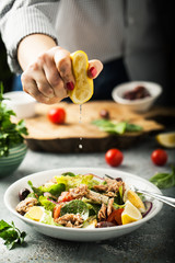 Young Woman in the process of making salad