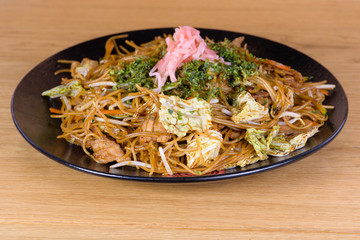 soy spaghetti with chicken and  vegetables, served on a decorated plate