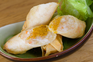 Harumaki, fried rolls in batter with shrimp pulp, flavoured with paprika, served with green salad...