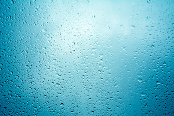 water drops on blue background / Drops of rain on glass , rain drops on clear window / Blue Abstract Water Drops Background / water drops on glass surface as background.