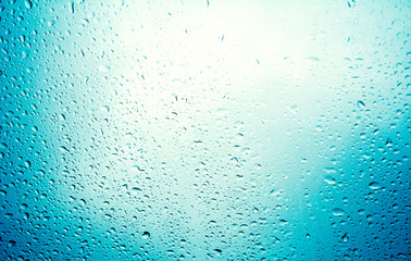 water drops on blue background / Drops of rain on glass , rain drops on clear window / Blue Abstract Water Drops Background / water drops on glass surface as background.