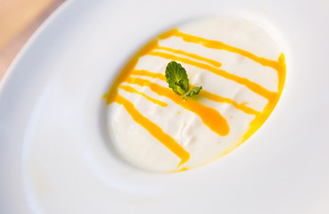 Dessert cream yougurt with  passion fruit puree at plate