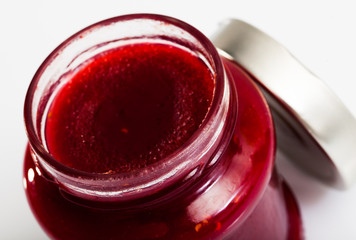 Closeup of raspberry jam in glass jar