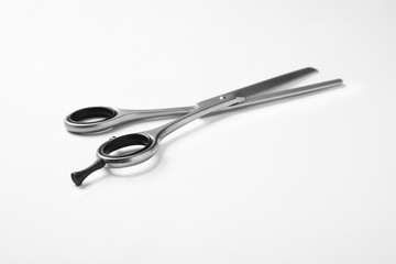New thinning scissors on white background. Professional hairdresser tool