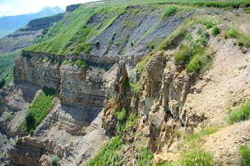 The Caucasus Mountains, high mountains, green meadows and snow-capped mountains.