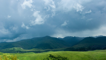 Fototapeta na wymiar The Caucasus Mountains, high mountains, green meadows and snow-capped mountains.