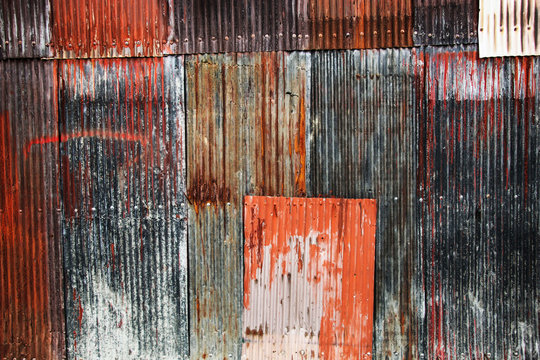Background image of rusty corrugated metal iron sheets red and blue colors