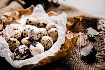 Quail eggs in paper on the kitchen table.