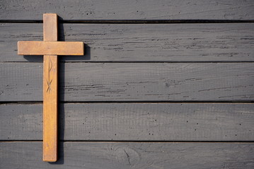 Christian cross on the wooden table 