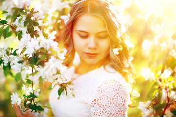 spring girl apple flowers, nature portrait of happy girl with long hair in blooming apple trees, freedom purity concept of happiness