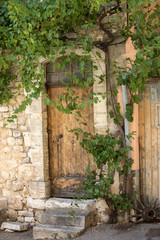 Fototapeta na wymiar old tenement house overgrown with ivy in Sault, Vaucluse department in Provence region, France