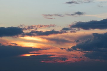 Beautiful dark dramatic clouds in the sky at sunset, natural background 