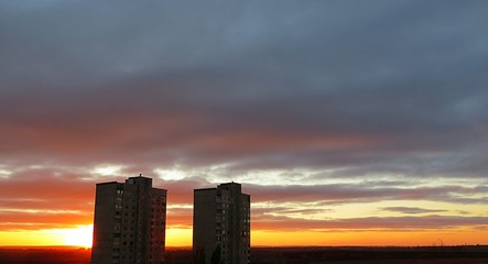 Beautiful burgundy sunset background over the city 