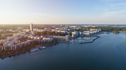 Fototapeta na wymiar Apartment buildings in the Vuosaari district of Helsinki at sunset, Finland. Beautiful summer panorama