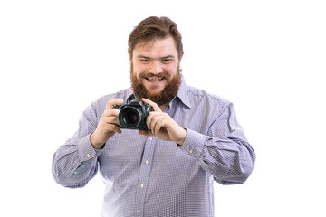 portrait of big handsome bearded photographer taking photo with professional DSLR camera, isolated on white