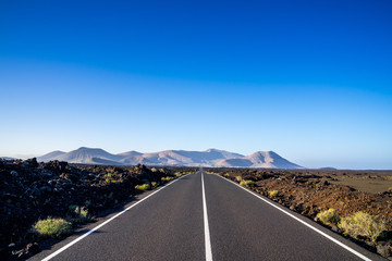 Spain, Lanzarote, Magical infinite bolt upright asphalt route alongside lava fields