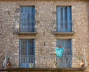 Fototapeta na wymiar Old stone house with wooden blue windows, Provence, France.