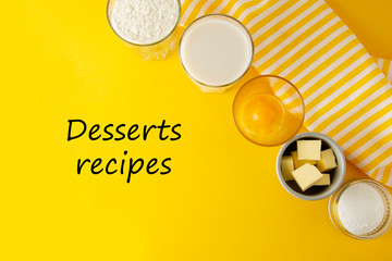 Desserts recipes inscription, lettering. Ingredients frame for baking pastry or dessert - butter, flour, eggs, milk, sugar. Yellow background.