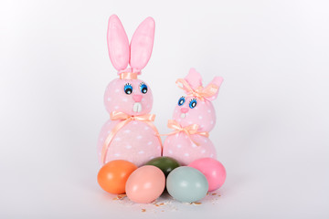 The pink easter male and female hand-made bunnies and easter eggs