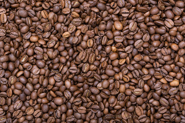 A lot of roasted fine coffee beans. Coffee beans background. Concept view.