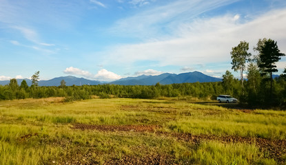Panoramic view of the field, rocks  and the sky. Lake Baikal, Russia.