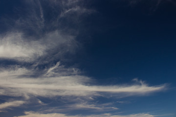 Naklejka na ściany i meble dark evening blue sky natural background with white clouds 