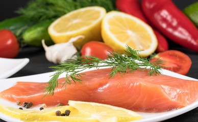red fish with lemon on white plate