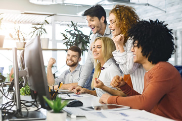 Millennials enjoying great results on computer screen