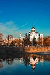 Fototapeta na wymiar Russian church reflecting in Yekaterinburg city pond
