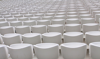 Fototapeta premium rows of empty white seats in the sports stadium