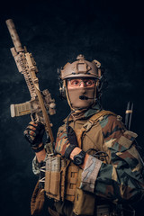 Obraz premium Elite unit, special forces soldier in camouflage uniform posing with assault rifle.